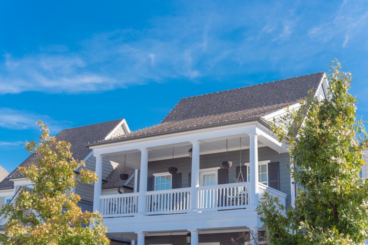 Upward view of second story balcony of urban townhome near Dallas, Texas, USA house with a deck